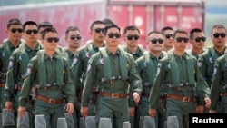 Members of Chinese People's Liberation Army (PLA) Air Force Red Falcon aerobatic team attend the China International Aviation and Aerospace Exhibition in Guangdong province, China, Sept. 28, 2021. 