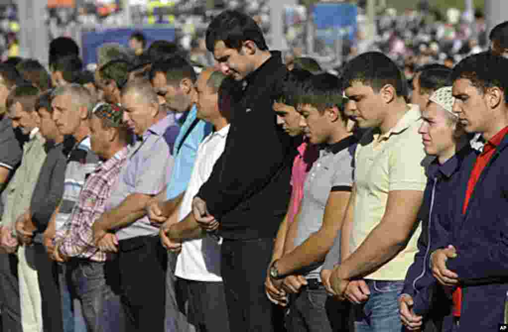 Russian Muslims attend Eid al-Fitr prayers outside the main Mosque in Moscow, Russia, Aug. 30, 2011. AP