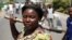 A female protester holds an ax during a protest against Burundian President Pierre Nkurunziza's decision to run for a third term in Bujumbura, Burundi, May 13, 2015.