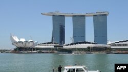 FILE - A Singapore Police Coast Guard boat patrols in the Marina Bay area in Singapore.