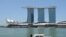 FILE - A Singapore Police Coast Guard boat patrols in the Marina Bay area in Singapore.