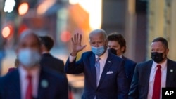 President-elect Joe Biden waves as he leaves The Queen theater in Wilmington, Delaware, Nov. 24, 2020.