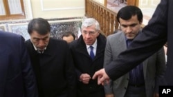 British politician Jack Straw, center, is welcomed to Iranian parliament lawmaker Abbasali Mansouri, left, Tehran, Jan. 7, 2014.