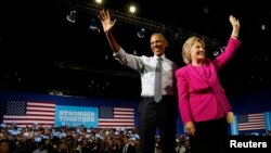 President Barack Obama waves to the crowd with Democratic presidential candidate Hillary Clinton during a Clinton presidential campaign event in Charlotte, North Carolina, July 5, 2016.