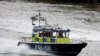 FILE - A police launch travels along the Thames near London Bridge.