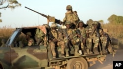 FILE - ECOWAS Senegalese troops in Barra, across from the Gambian capital Banjul Jan. 22, 2017. ECOWAS has threatened the use of force in reinstating the president of Niger after he was deposed by his military but how the bloc would carry out the threat remains unclear..