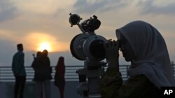 FILE —A member of staff uses a telescope to search for the new moon that signals the start of Ramadan, at the Astronomical Observatory of the Muhammadiyah University of North Sumatra in Medan, Indonesia, March 10, 2024.