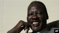 Former NBA star Manute Bol poses for a photograph at the Sunrise Sudan headquarters June 9, 2008, in Lenexa, Kansas.