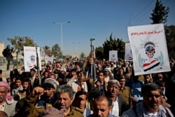 FILE - Houthi supporters chant slogans during a rally outside the closed U.S. Embassy over the decision of the Trump administration to designate the Houthis a foreign terrorist organization, in Sanaa, Yemen, Jan. 18, 2021.