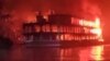 This frame grab from an AFPTV video shows a burning ferry after it caught on fire killing at least 37 people in Jhalkathi, 250 kilometers (160 miles) south of Dhaka, early on Dec. 24, 2021.