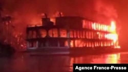 This frame grab from an AFPTV video shows a burning ferry after it caught on fire killing at least 37 people in Jhalkathi, 250 kilometers (160 miles) south of Dhaka, early on Dec. 24, 2021.