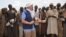 A picture taken on April 18, 2013 shows Claus Sorensen, director-general of the European Commission Humanitarian Aid and Civil Protection (ECHO), speaking with farmers Maï-Rounfa, southeastern Niger.