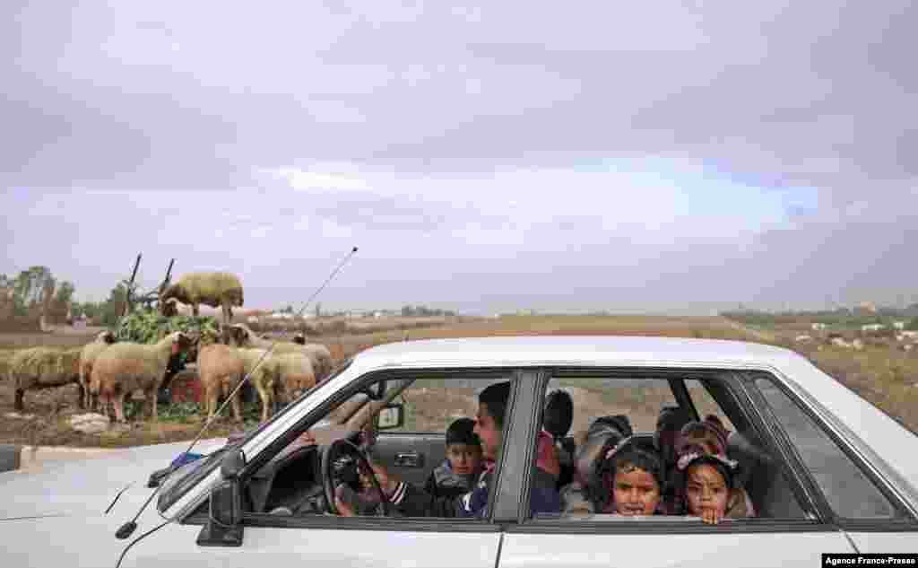 Palestinian children look on as they are driven home from school in Gaza City.