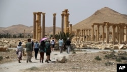 FILE - Tourists visit Roman ruins in Palmyra, Syria, on May 11, 2023. Syrian state-run media reported on Nov. 20, 2024, that a strike on the historic town killed 36 people. Syrian leaders blamed Israel.