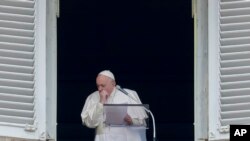 Pope Francis coughs during the Angelus noon prayer he recited from the window of his studio overlooking St. Peter's Square, at the Vatican, March 1, 2020.