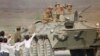 Afghan children and a soldier bid farewell to Soviet soldiers riding atop an armored personnel carrier as the official troop withdrawal begins after nearly a decade long military intervention in war-torn Afghanistan, Sunday, May 15, 1988, Kabul, Afghanist