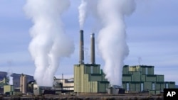 FILE - Steam billows from a coal-fired power plant Nov. 18, 2021, in Craig, Colorado.