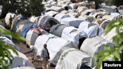 FILE - Victims of ethnic violence are seen at a makeshift camp for internally displaced people, in Bunia, Ituri province, in the eastern Democratic Republic of Congo, June 25, 2019.