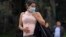 A pregnant woman wears a face mask as a preventive measure against the spread of the new coronavirus, COVID-19, as she waits for the bus in Bogota, on March 16, 2020.