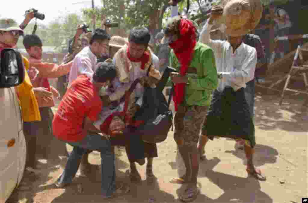 Student protesters carry a colleague who fainted during a protest in Letpadan, Myanmar, March 10, 2015.