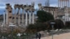 FILE - People walk near the Roman ruins of Baalbek, Lebanon, Jan. 5, 2024. 