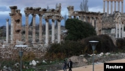 FILE - People walk near the Roman ruins of Baalbek, Lebanon, Jan. 5, 2024. 