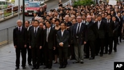 Hundreds of Hong Kong lawyers dressed in black march in silence in Hong Kong, June 27, 2014, to protest a recent Beijing policy statement they say undermines the Asian financial hub’s rule of law.