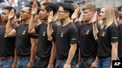 FILE - New Army recruits take part in a swearing in ceremony before a baseball game between the San Diego Padres and the Colorado Rockies Sunday, June 4, 2017, in San Diego. (AP Photo/Gregory Bull)