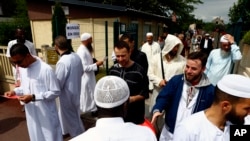 Muslim worshipers walk out after the friday prayer at the Yahya Mosque, in Saint-Etienne-du-Rouvray, Normandy, France, July 29, 2016. Four days after the hostage taking in Saint-Etienne-du-Rouvray, officials and worshipers of the Muslim community paid tribute to priest Jacques Hamel and Christian community. 