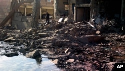 A suicide attacker detonates a car bomb at a Syrian security compound in a remote, predominantly Kurdish area, killing at least four people, Sept. 30, 2012.