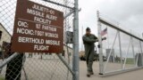 FILE - This photo taken June 24, 2014 shows Capt. Robby Modad closing the gate at an ICBM launch control facility in the countryside outside Minot, N.D., on the Minot Air Force Base. (AP Photo/Charlie Riedel)

