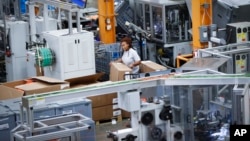 FILE - An employee works on a factory floor at a Stihl Inc. production plant in Virginia Beach, Va, May 25, 2017. On Tuesday, Sept. 5, 2017, the Commerce Department reports on U.S. factory orders for July.