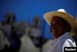 Cruz Gomes, a 44-year-old migrant from Guatemala, part of a caravan of thousands from Central America en route to the United States, smiles while rests in Santiago Niltepec, Mexico, Oct. 29, 2018.