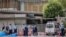 Police  investigate a vehicle that crashed into a barricade outside the prime minister's Tokyo residence on Oct. 19, 2024, after a man threw Molotov cocktail-like objects outside the ruling party's headquarters building, hit a riot police vehicle and drove into the barricade.