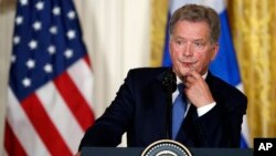 FILE - Finnish President Sauli Niinisto listens to a question during a news conference with President Donald Trump in the East Room of the White House in Washington, Aug. 28, 2017.