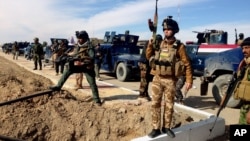 FILE - Iraqi Security forces preparing to attack al-Qaida positions in Ramadi, 70 miles (115 kilometers) west of Baghdad, Iraq. Militants, many from the al-Qaida-breakaway group Islamic State in Iraq and the Levant, overran Fallujah and parts of Anbar’s capital, Ramadi.