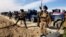 FILE - Iraqi Security forces preparing to attack al-Qaida positions in Ramadi, 70 miles (115 kilometers) west of Baghdad, Iraq.  Militants, many from the al-Qaida-breakaway group Islamic State in Iraq and the Levant, overran Fallujah and parts of Anbar’s capital, Ramadi.