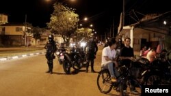 Police officers patrol a street in the working-class neighborhood of Caimbe on Boa Vista's west side where most Venezuelan immigrants live, Roraima state, Brazil, Nov. 18, 2017.