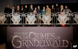 From left, Lionel Wigram,David Heyman, David Yates,William Nadylan,Claudia Kim,Callum Turner, Zoe Kravitz, Jude Law, J.K Rowling, Eddie Redmayne,Katherine Waterston,Ezra Miller,Alison Sudol and Dan Fogler pose at the world premiere of the film "Fantastic