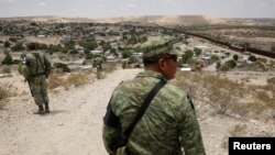 Members of the Mexican National Guard patrol the border with the United States, as seen from Anapra neighborhood, on the outskirts of Ciudad Juarez, Mexico, July 24, 2019. 