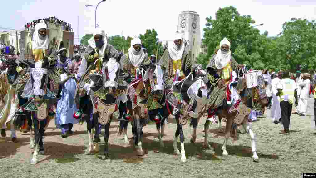 Horsemen pay homage to Emir of Kano Alhaji Ado Bayero during an event marking his 50th year on the throne.