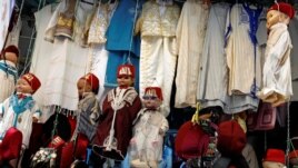 FILE - Dolls dressed in the traditional clothes are displayed at a clothing store at the Medina of Tunis, Tunisia, September 25, 2018. (REUTERS/Zoubeir Souissi)