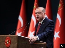 FILE - Turkey's President Recep Tayyip Erdogan announces early presidential and parliamentary elections for June 24, 2018, at the Presidential Palace, in Ankara, Turkey, April 18, 2018.