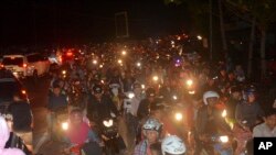 Motociclistas procuram sair do epicentro do terramoto, Java, 16 de Dezembro, 2017. 