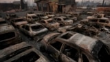 Cars are left charred inside a dealership in the aftermath of the Eaton fire in Altadena, California, Jan. 10, 2025.