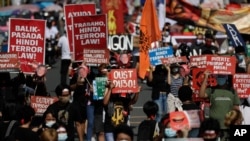 Protesters march as they hold a rally at the University of the Philippines against the 5th State of the Nation Address (SONA) by Philippine President Rodrigo Duterte on Monday, July 27, 2020 in Metro Manila, Philippines. Hundreds of protesters in…