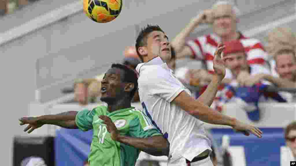 Nigeria's GoDrey Oboabona and United States's Alejandro Bedoya.