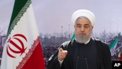 In this photo released by the Iranian president's office, President Hassan Rouhani addresses the nation in a televised speech in Tehran, Feb. 10, 2021.
