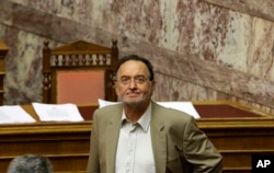 FILE - Greece's Energy Minister Panagiotis Lafazanis arrives at a parliament meeting in Athens, July 15, 2015.