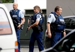 Armed police patrol outside a mosque in central Christchurch, New Zealand, March 15, 2019. A witness says many people have been killed in a mass shooting at a mosque in the New Zealand city of Christchurch.